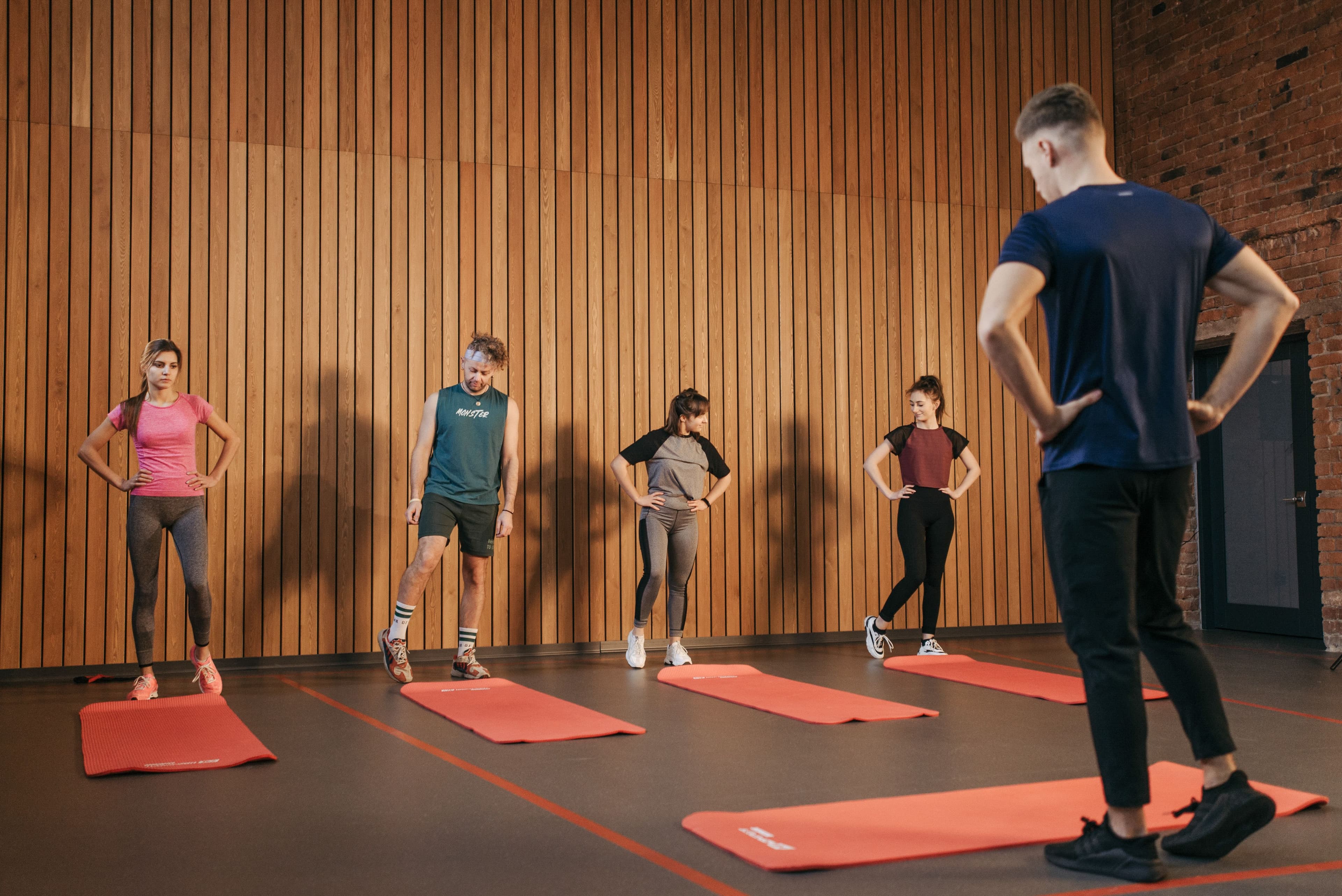 Trainer coaching a client through a workout — the kind of professional Hello You Wellness partners with